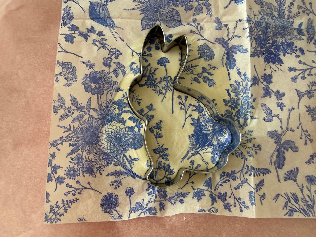 Lay one ply of patterned napkin over rolled out-air dry clay and cut with a bunny cookie cutter.