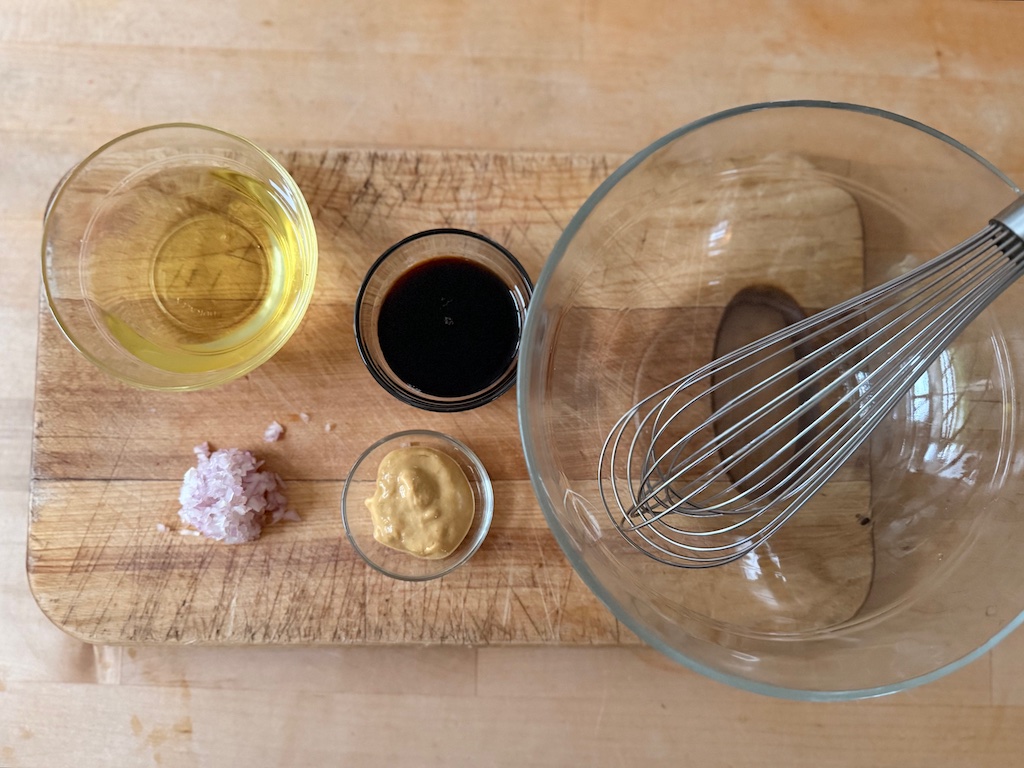 Ingredients for balsamic vinaigrette: extra virgin olive oil, balsamic vinegar, mustard, and shallots.
