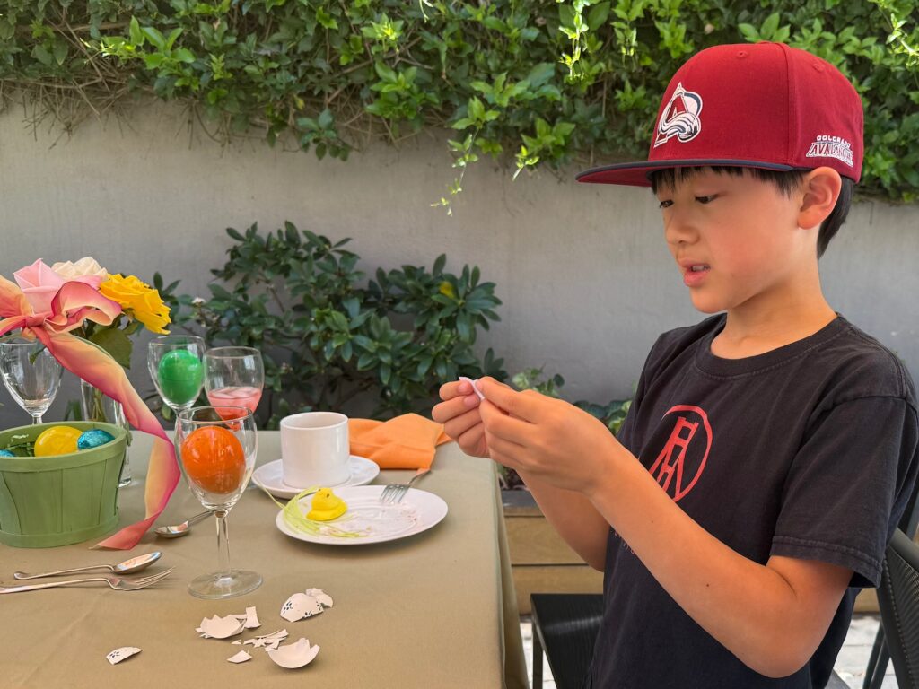 Child reads the first clue after cracking the egg. Now the hunt begins!