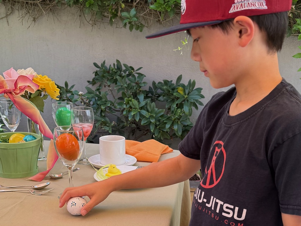 Child cracks a real egg-hollowed and decorated--with the first clue inside.