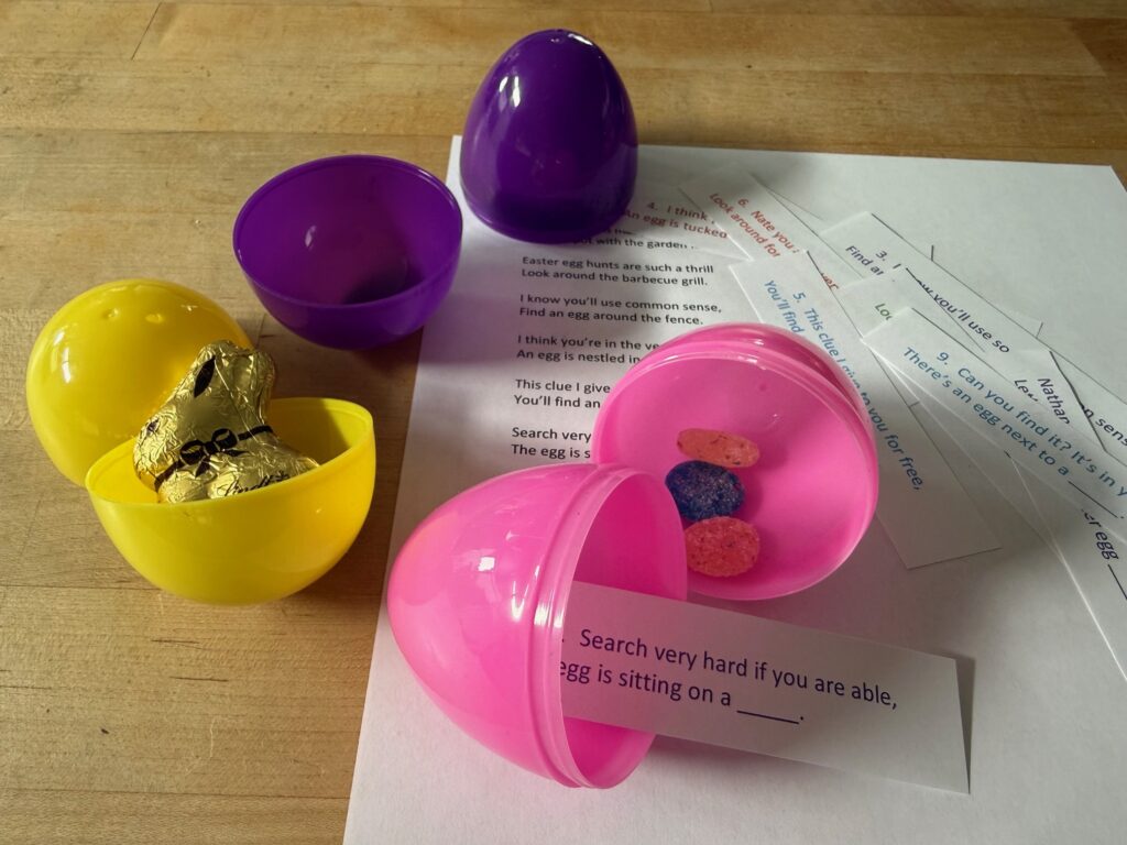 Stuff plastic eggs with a clue printed on strips of paper, and a treat.
