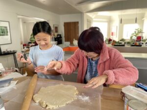 Grandma and grandchild making pie together. Caring for grandkids can help with mental acuity.