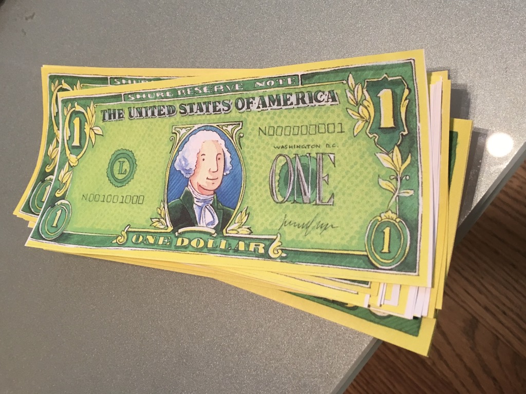 Play money illustrates a section on finance. The money was used to play restaurant and cookie shop with the grandkids.