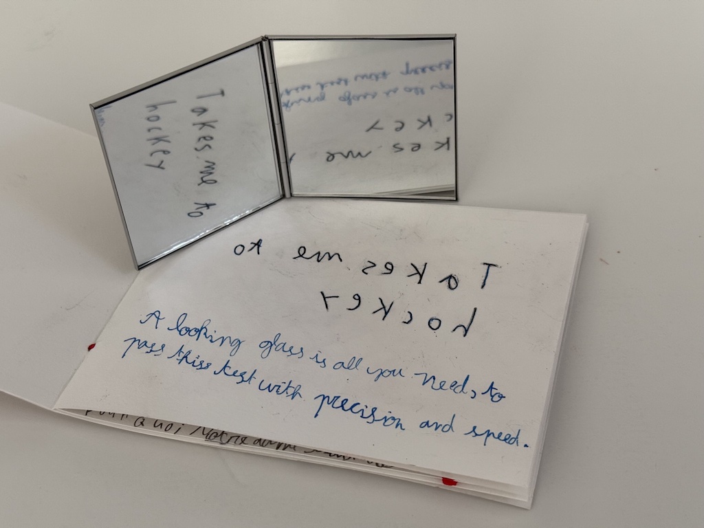 A mirror is used to reveal the message, which is written backwards by writing on tissue paper, flipping the paper over, and tracing the message.