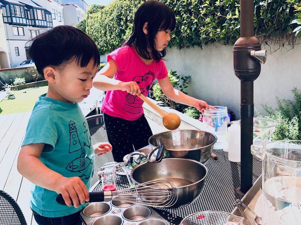 Kids cook up a storm in the backyard with bowls, muffin tins, whisks, and spoons. Getting wet is part of the fun.