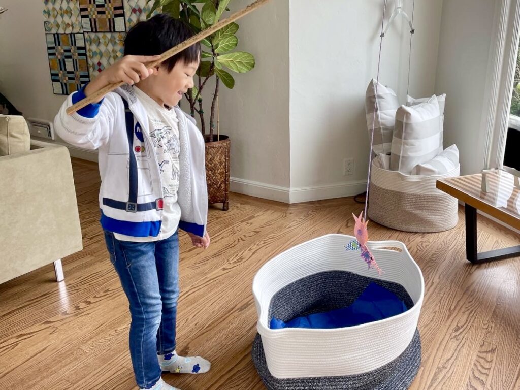 A fun summer activity that kids can enjoy indoors when it's too hot to play outside, is to create a fishing game with a magnet hook attached with yarn to a yardstick, and paper fish with paper clips.