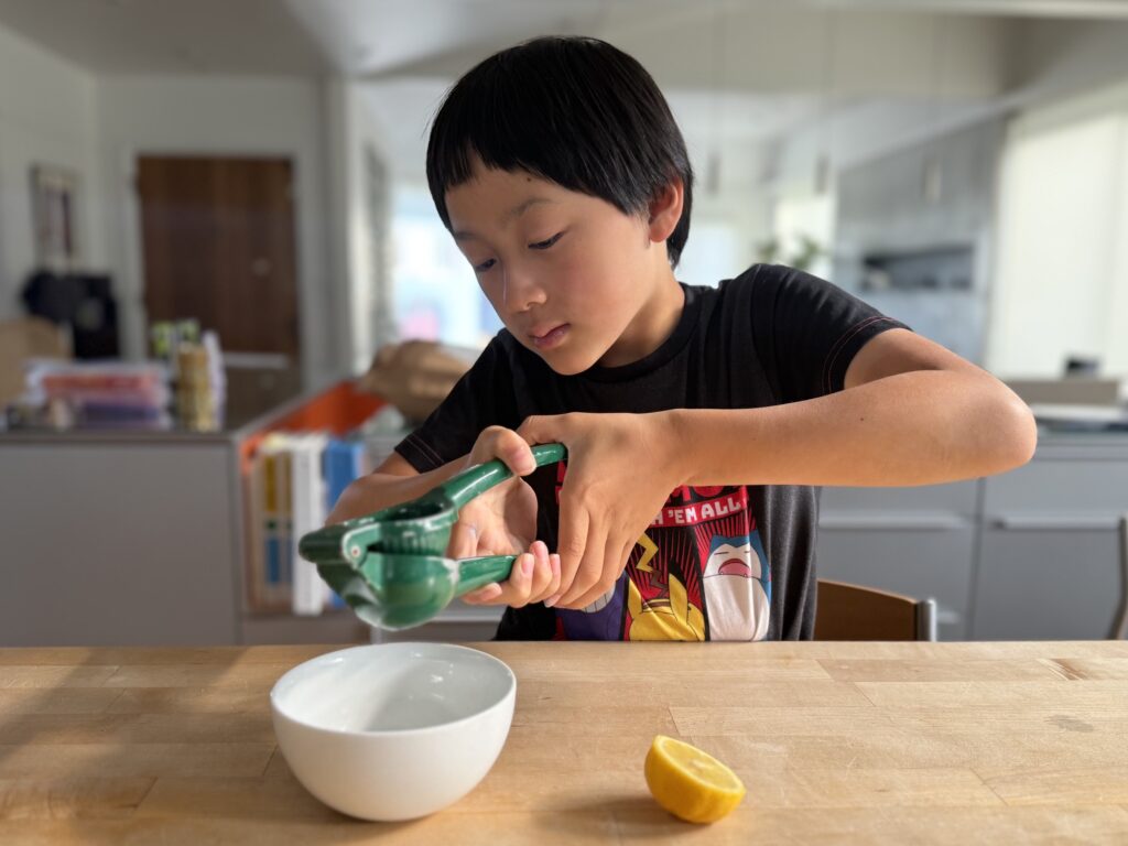 Creating fun summer activities for your grandchild might include learning to create secret messages in invisible ink. Child squeezes lemon to make lemon juice invisible ink.