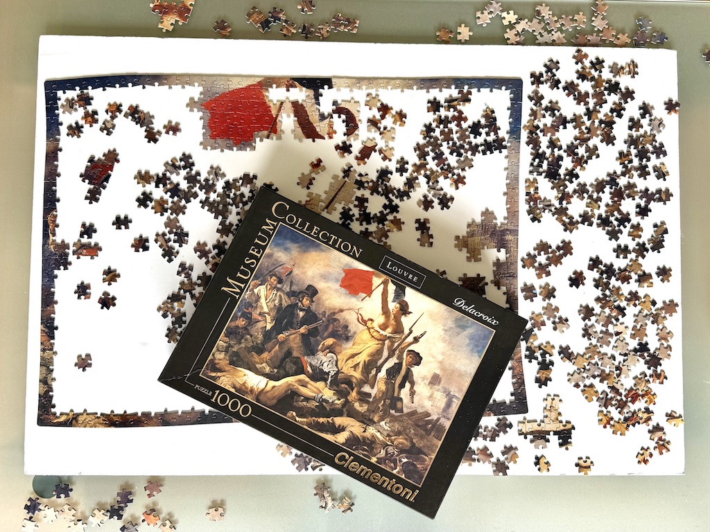Jigsaw puzzle is set on a foam core board so that the whole puzzle can be moved without disturbing the pieces when the table it sits on is needed