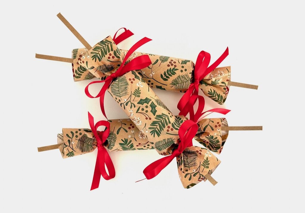 Homemade Christmas crackers are filled with a paper crown, a joke, and a prize. When pulled apart, they make a satisfying "bang."