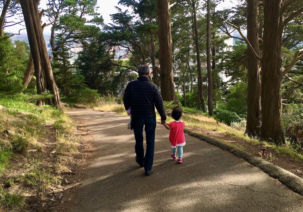 Grandparent and grandchild out for a walk. It's a good time for conversatiion.