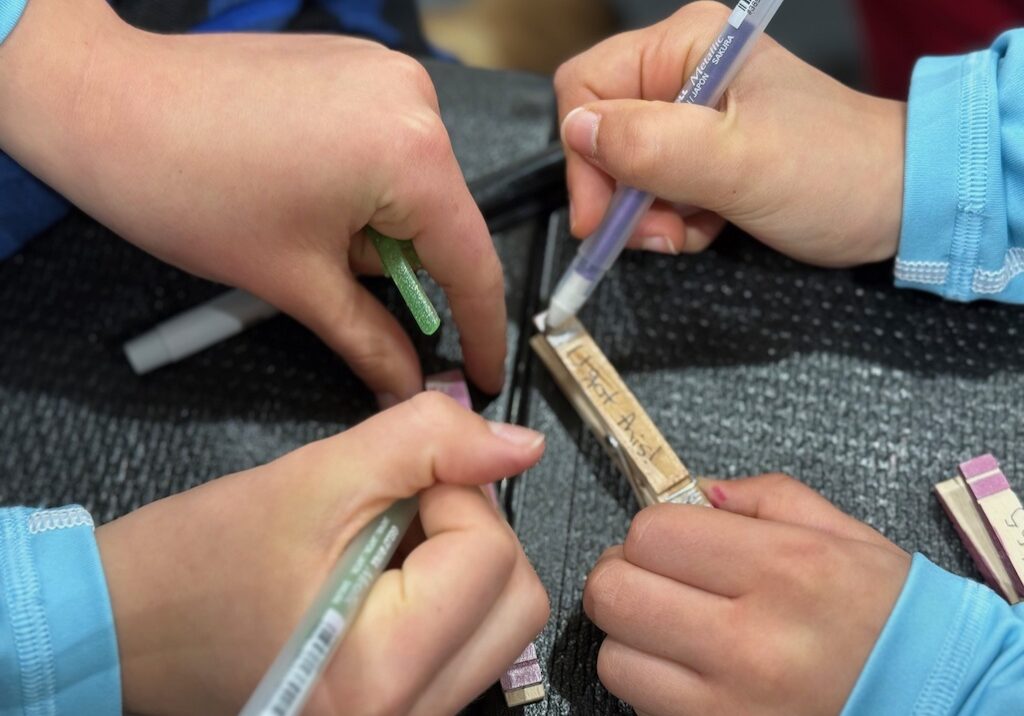 Clips are wooden clothespins decorated with affirming messages by girls on volleyball teams who give them randomly to other players.