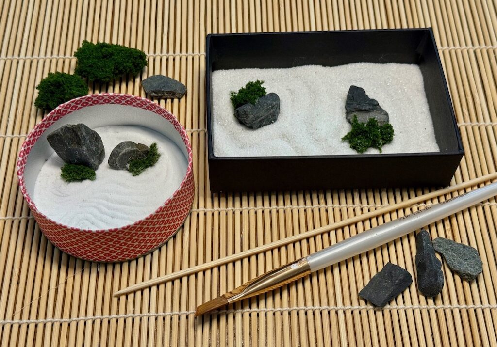 Two finished mini zen gardens, tools, and materials to make a Father's Day gift.